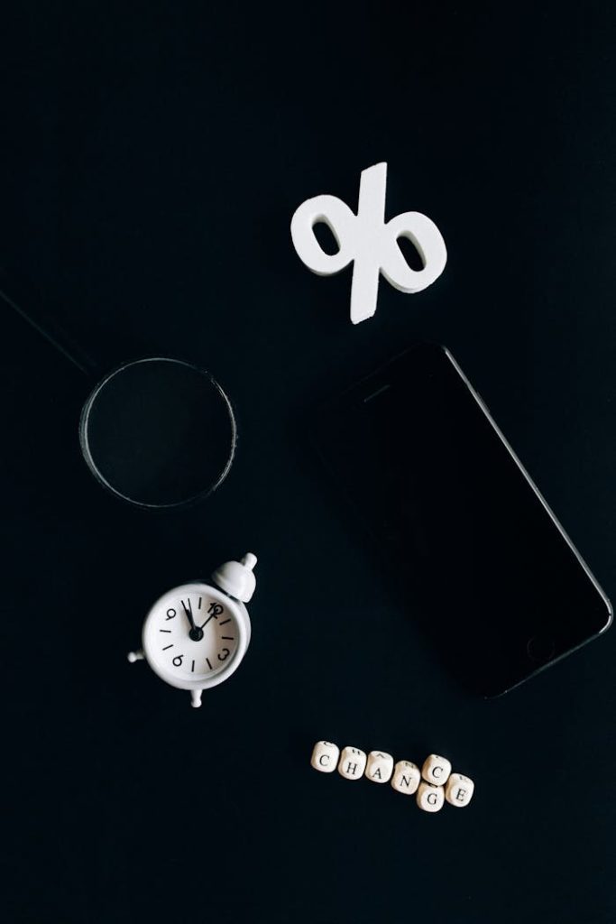 Stylish composition of clock, symbols, and text representing financial change on a dark background.